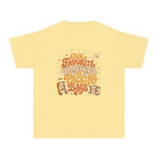 Our Favorite Tradition Is Packing Bags Youth Tee – Kids' Comfort Colors Family Travel Shirt in Butter – flat lay