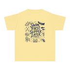 Swim First Supper Later Youth Tee – Kids' Comfort Colors Lake Vacation Shirt in Butter – flat lay