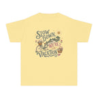 Slow Down We're on Vacation Youth Tee – Kids' Comfort Colors Travel Shirt in Butter – flat lay