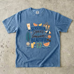 Sunscreen Snacks and Somewhere Beautiful Beach Vacation Shirt in Blue Jean – flat lay