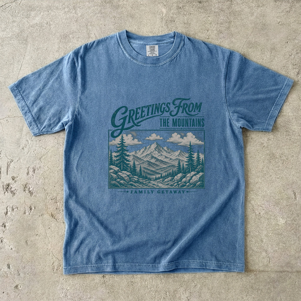 Greetings from the Mountains Family Getaway Shirt in Blue Jean – flat lay