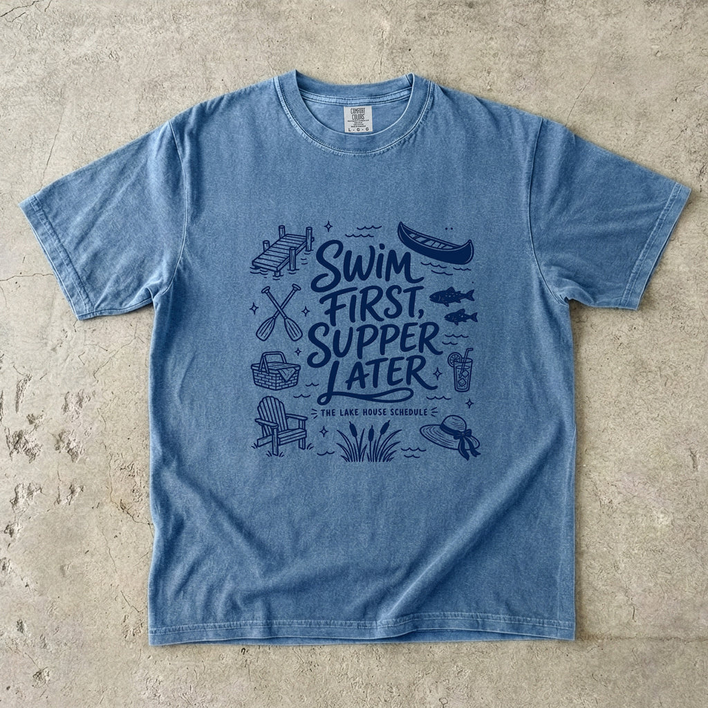 Swim First Supper Later Lake Vacation Shirt in Blue Jean – flat lay