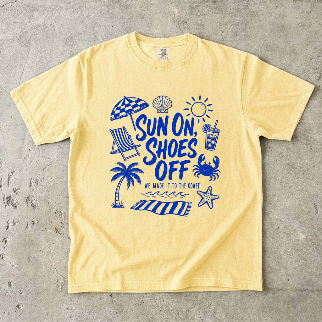 Sun On Shoes Off Beach Vacation Shirt in Butter – flat lay
