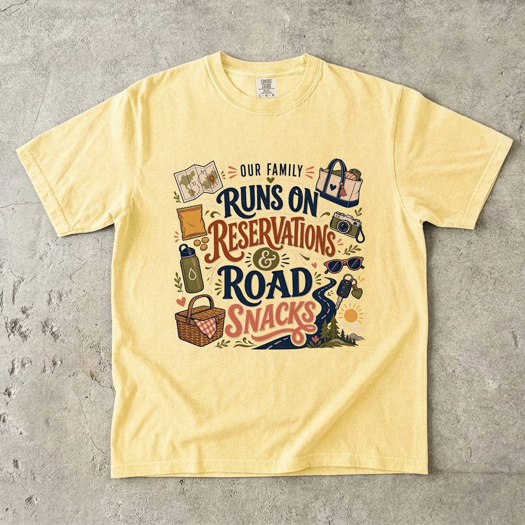 Our Family Runs on Reservations and Road Snacks Road Trip Shirt in Butter – flat lay