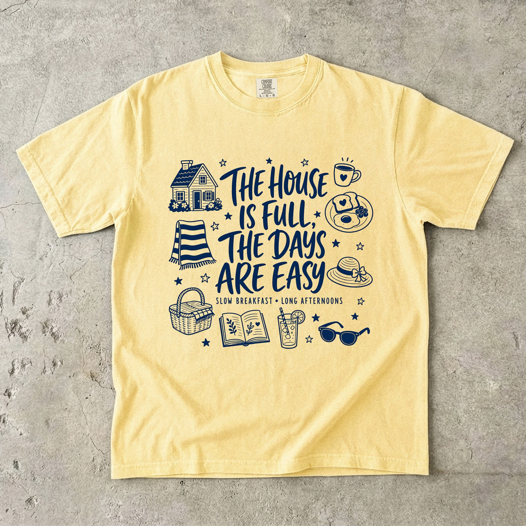 The House Is Full the Days Are Easy Family Getaway Shirt in Butter – flat lay
