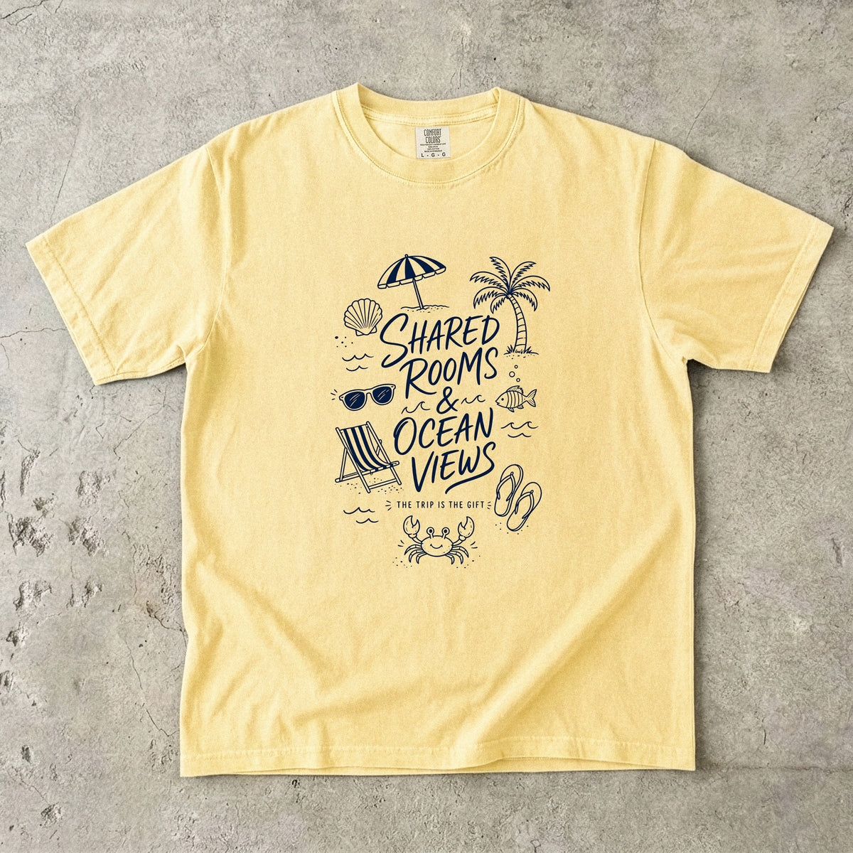 Shared Rooms and Ocean Views Girls Trip Shirt in Butter – flat lay