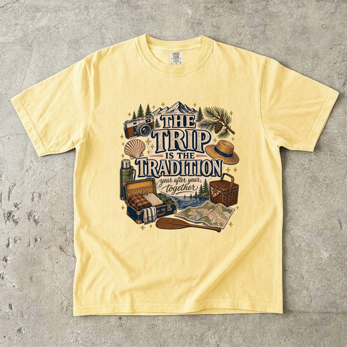 The Trip Is the Tradition Lake Vacation Shirt in Butter – flat lay