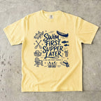 Swim First Supper Later Lake Vacation Shirt in Butter – flat lay
