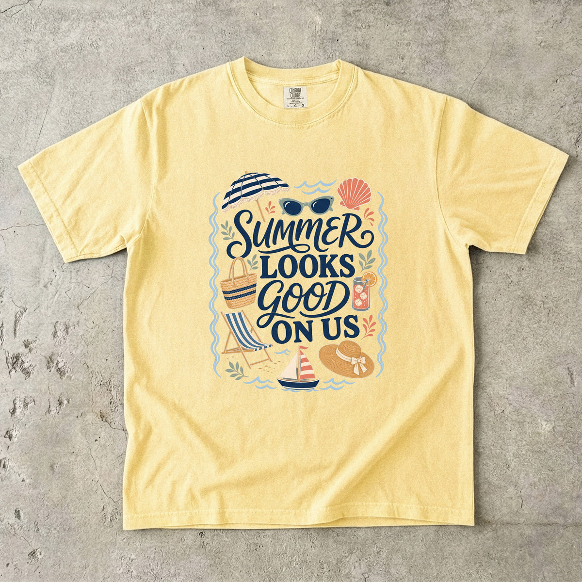 Summer Looks Good On Us Beach Vacation Shirt in Butter – flat lay