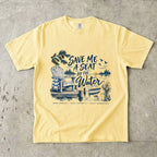 Save Me a Seat by the Water Lake Vacation Shirt in Butter – flat lay