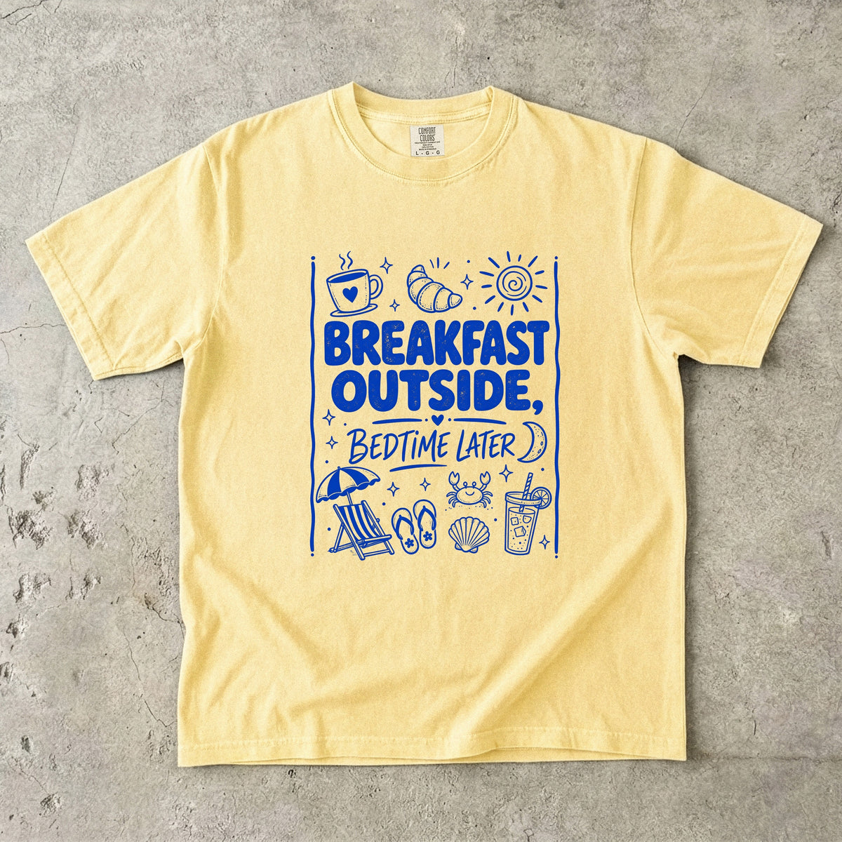 Breakfast Outside Bedtime Later Beach Vacation Shirt in Butter – flat lay