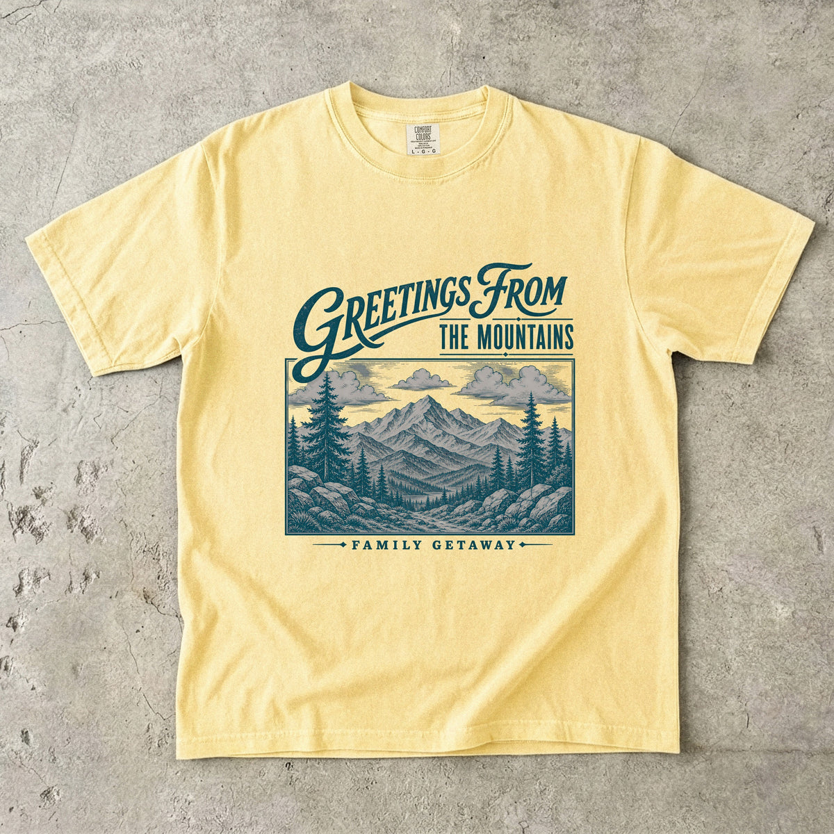 Greetings from the Mountains Family Getaway Shirt in Butter – flat lay