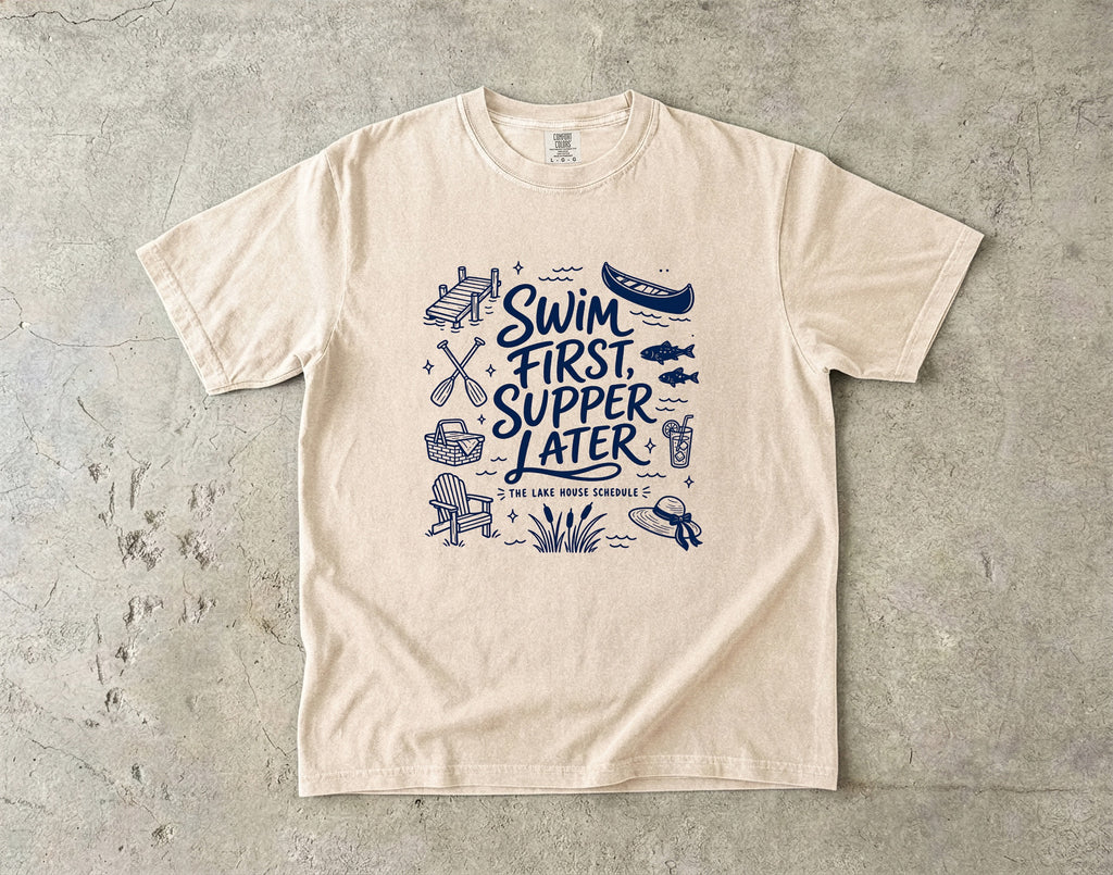 Swim First Supper Later Lake Vacation Shirt in Ivory – flat lay