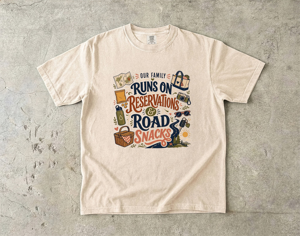 Our Family Runs on Reservations and Road Snacks Road Trip Shirt in Ivory – flat lay
