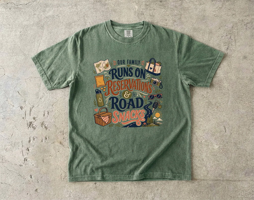 Our Family Runs on Reservations and Road Snacks Road Trip Shirt in Moss – flat lay