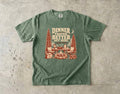 Dinner Tastes Better Out Here Camping Shirt in Moss – flat lay