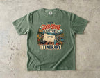 The Good Stuff Happens Off the Itinerary Travel Mom Shirt in Moss – flat lay