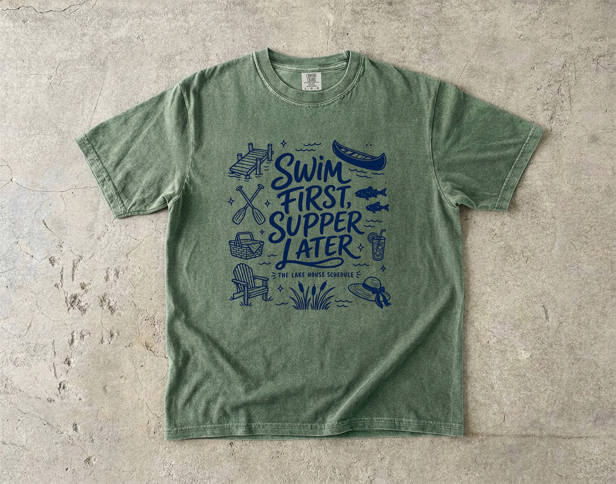 Swim First Supper Later Lake Vacation Shirt in Moss – flat lay
