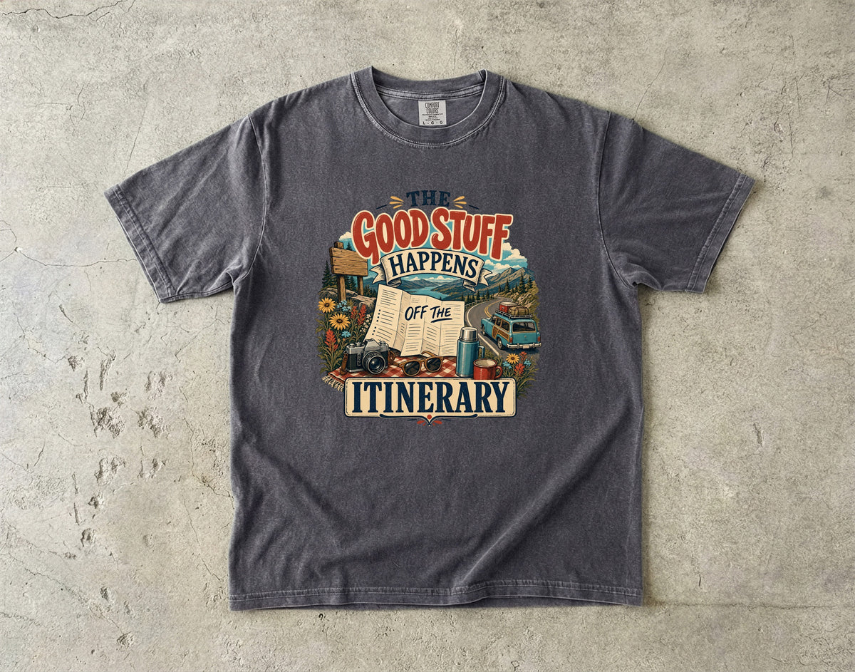 The Good Stuff Happens Off the Itinerary Travel Mom Shirt in Pepper – flat lay